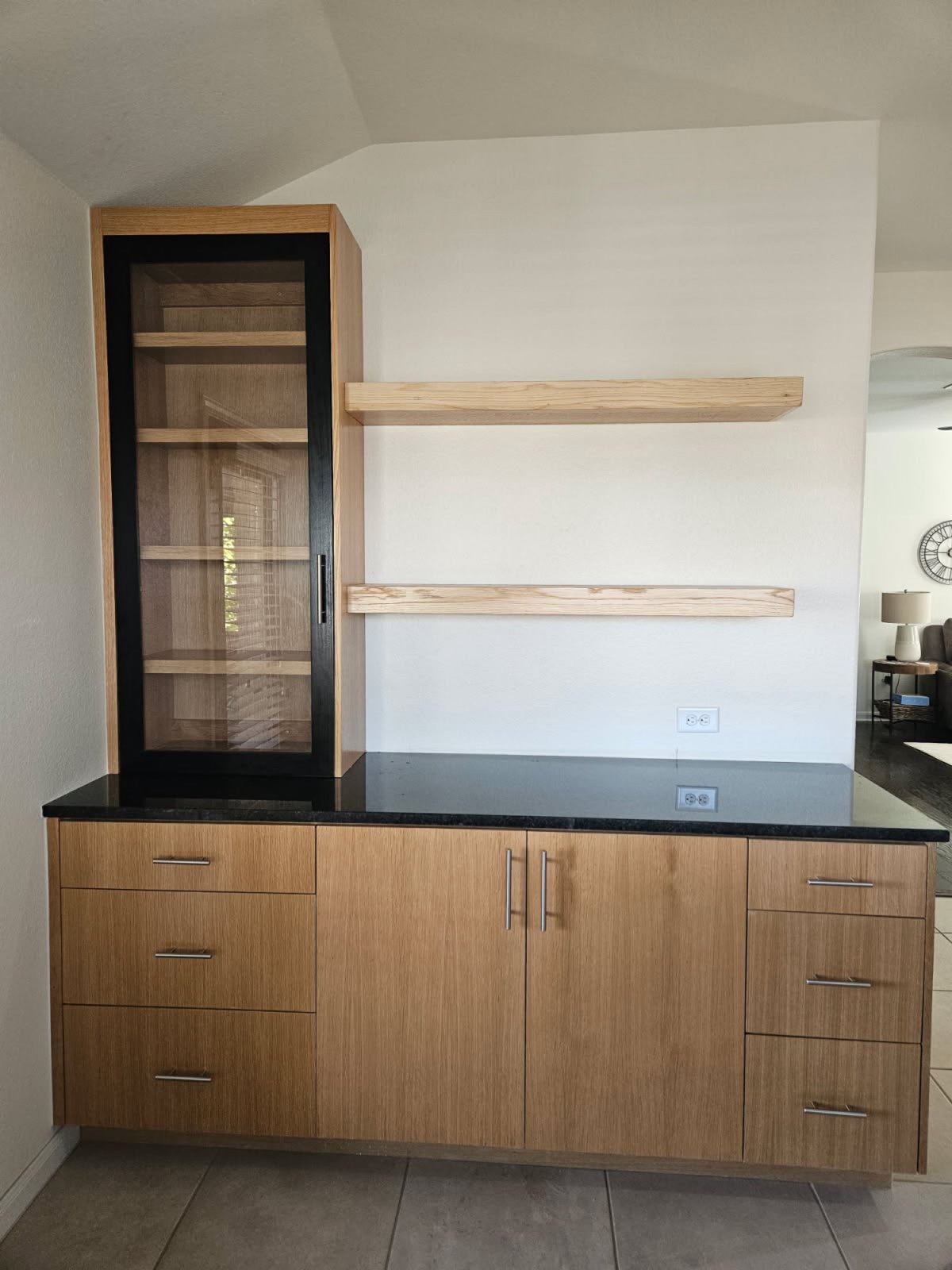 Custom oak hutch with black frame and floating shelves, built-in millwork in an Austin-area home